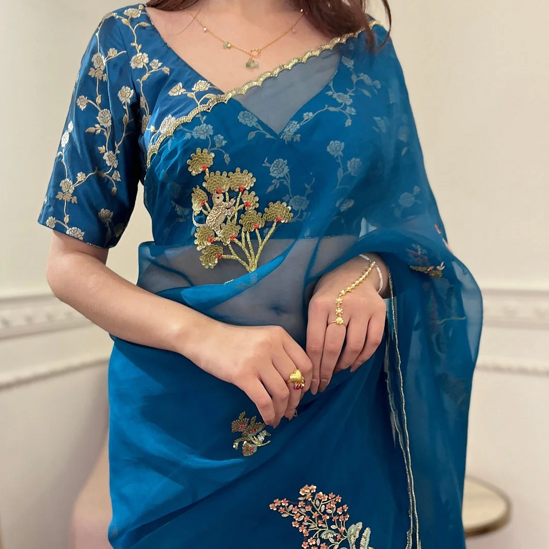 Blue organza saree with hand embroidery exudes elegance and luxury