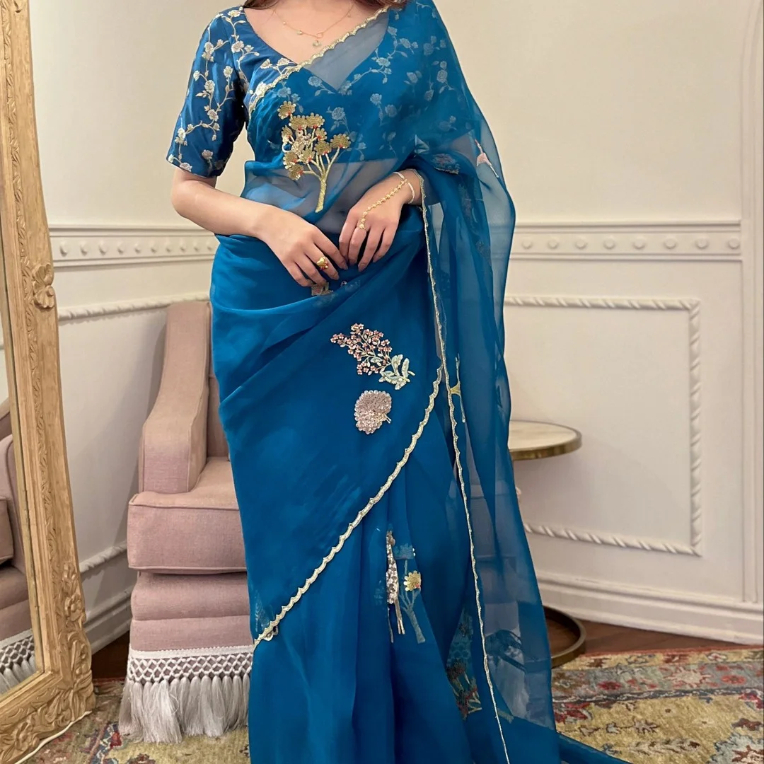Blue organza saree with hand embroidery exudes elegance and luxury — 2